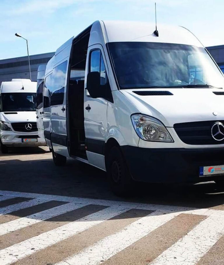 White Mercedes-Benz minibuses, with one of them having its passenger door open