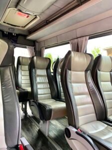 Modern minibus interior with leather seats and large windows